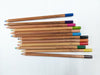 Kita-Boshi Color Pencils - 12 Pack with the individual pencils out of the box on a graph paper background